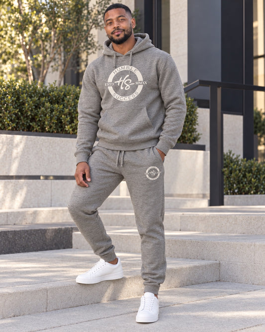 Male model wearing the Humble Success heather grey Signature Series hoodie and joggers